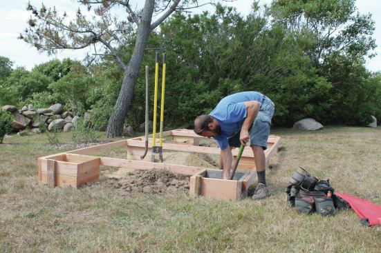 After the boxes are connected by a perimeter of 2-bys, the entire assembly is leveled at once and staked in place.