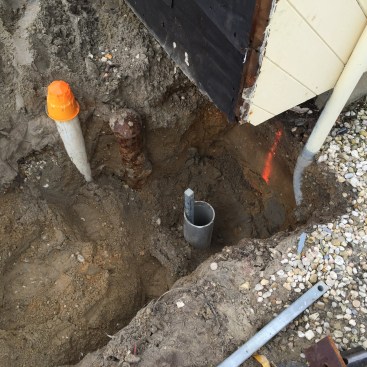 When the helical pier is close to its final depth, a PVC pipe is driven down around the shaft.