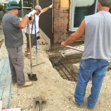 Concrete goes into the trench with the dirt walls acting as forms. The existing footing forms part of the trench for the cantilever grade beam.