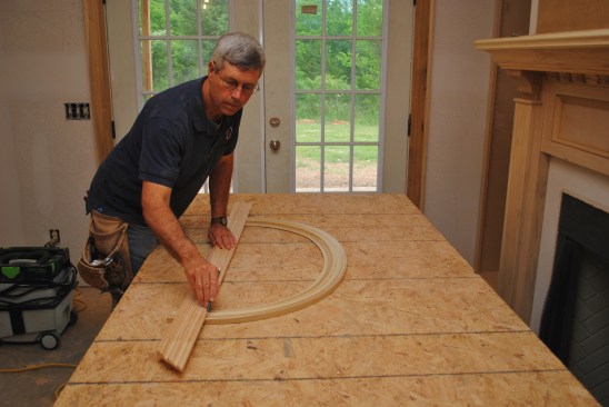 With a straightedge aligned with the transition marks, draw a line across both sides of the ellipse to guide the cut.