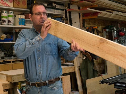 Rafter stock. I start by selecting material that’s as straight and free of twists as possible. Even good lumber usually has a bit of a crown, so I sight down the edge of the material, and place a mark pointing to the edge where the crown faces up. We will install the rafters with crowns facing up, so I place that side towards me on a bench or sawhorses.