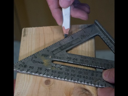 Plumb cut. I mark a plumb cut on the end of the rafter that will butt the ridge or ledger board. To do this, I line up a my square on the top edge of the rafter and pivot it until the appropriate slope mark (“7” on the square’s “Common” scale for a 7:12 roof) lines up with the board’s edge. Using a sharp pencil, I strike a line, and I use a circular saw with a good blade to cut this plumb line.