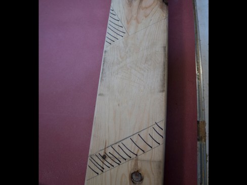 In this photo, I have used black hatch marks to note where the subfascia will land relative to my rafter. I can now make this plumb cut, chopping off the hatch marks.