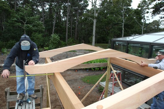 Crew members center each cross beam on the horizontal beams.