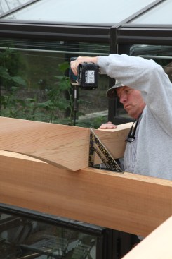 Then they drive the structural attachment screws while keeping the beams square to the top surface of the carrying beams below.