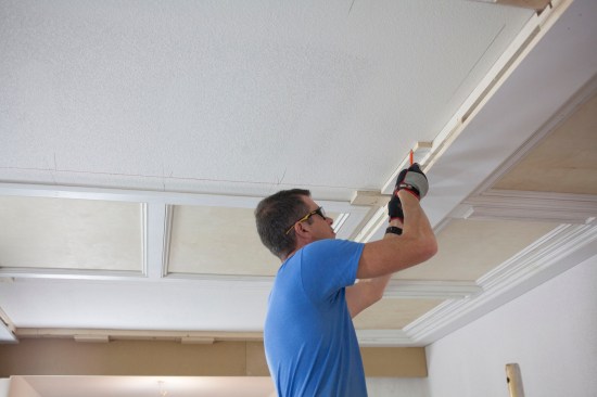 The panels end two inches from the major beam, and a crew member marks that distance with a 2-inch block. These marks give the crew the exact dimensions of the panels, and they act as alignment marks during installation.
