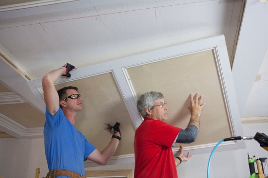 Two people make lifting and positioning the completed panels much easier.