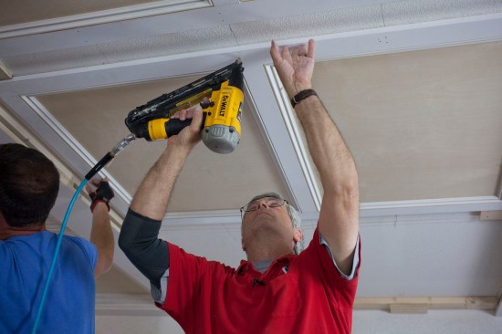 The author drives nails at every joist location to fasten the panels in place. 