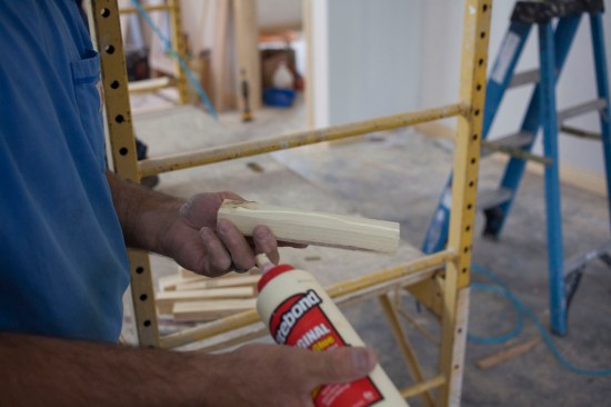 The crew rips 1-inch-thick nailing blocks to into the space between the panel frames and the major beams. The thickness equals the total thickness of the panels. Glue applied to the blocks help to hold them in place.