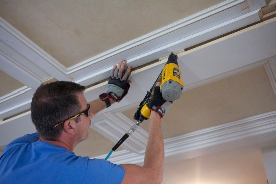 The next layer is just a 2 1/2-inch wide strip of 3/4-inch thick primed pine. The strip butts against the nailing blocks of the major beam and laps 1/2 inch onto the panel frame.
