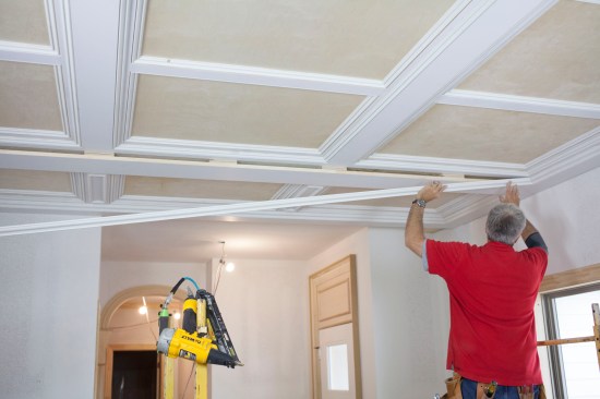 Bed molding completes the transition from the intermediate layer down to the bottom of the major beams. Here the author dry fits a length to make sure the bottom reveal stays consistent for the entire length of the molding.