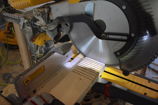 With the miter saw blade set a depth of 3/4 inch, the crew makes multiple cuts in the area of the notch.