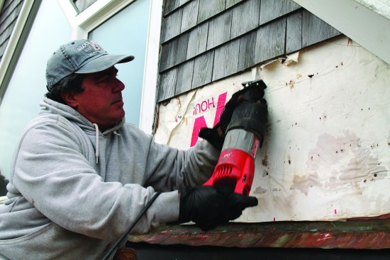 A shingle "thief" is a long flat bar that slips behind the shingle, hooks on the shingle nails, and pulls them out. That task is typically frustrating and arduous. Instead, a long recip saw blade cuts the nails behind the shingles so that the shingles can be removed more easily.