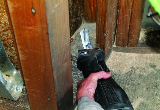 Recip saws can often get into tight spaces that other tools can't reach. With the right metal-cutting blade, the author can access this awkward space to slice off a bolt.