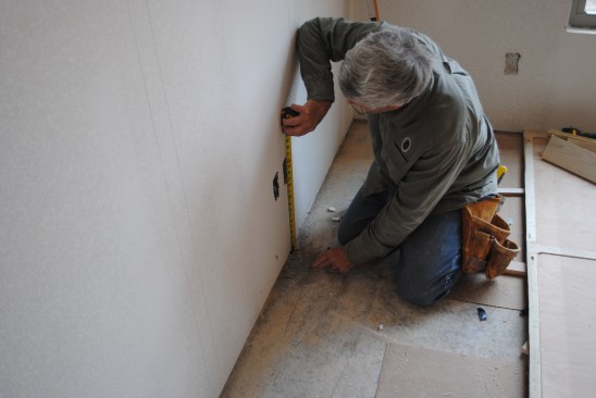 Then the author measures to the top and bottom of each box and marks the measurements next to the plumb marks. When the panel section is lifted into place, he merely reverses the process to locate and cut out the boxes in the panels. 