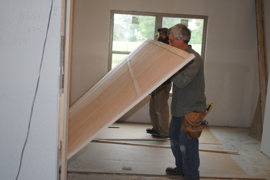 Because the panel assembly is fragile until it's in place, it needs to be lifted carefully and is best done with two crew members.