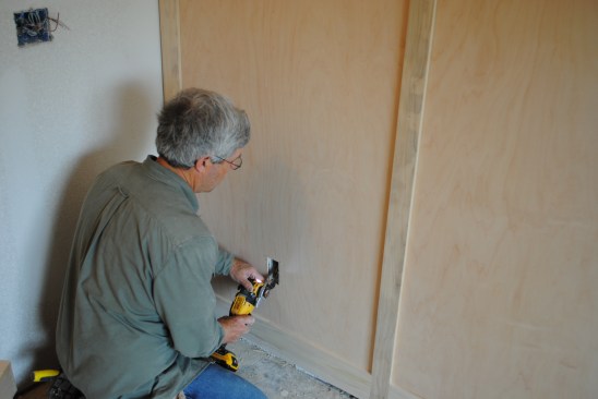 To verify the box locations, the author first cuts a small center hole, and then finishes cutting out the boxes with a multi-tool. 