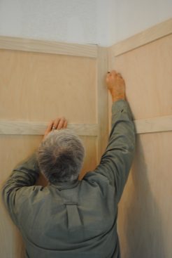 For a tight fit, the author scribes the corners with a pencil flat against the adjacent frame. 