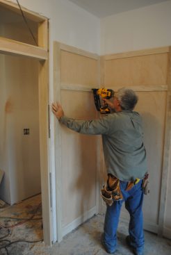 The author nails the side panels to the wall framing.