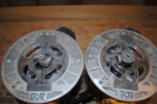 Two routers are fitted with different bits to cut the rabbets in the backs of the frames for the plywood panels.