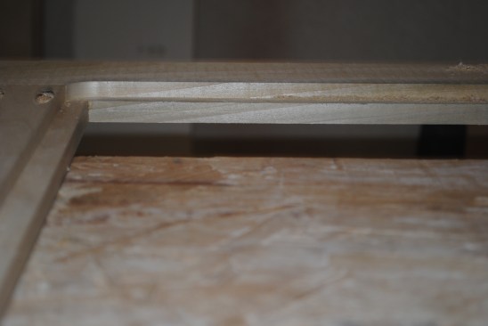 On the second pass, the router bit with the smaller bearing finishes the rabbet, hogging out the material to the full width of the rabbet.