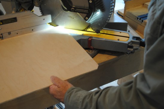 Instead of using a chisel to square up the rounded rabbet corners left by the router on the frame, the author just clips the panel corners with a miter saw.
