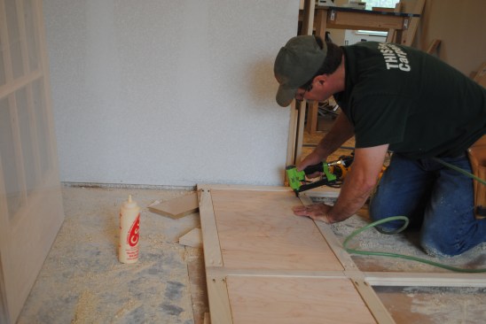 Medium crown staples hold the plywood panel tight against the frame while the glue dries. 