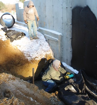 ... through sleeves cast into the footing.