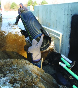 The culvert is muscled into place.
