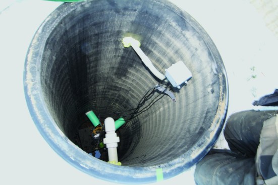 In this completed home’s sump, the pump-to-house wiring connections are made at a wall-mounted junction box.