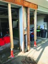 Before doing any more work on the support, the author propped up the continuous 6x12 header spanning the openings with a pair of house jacks.