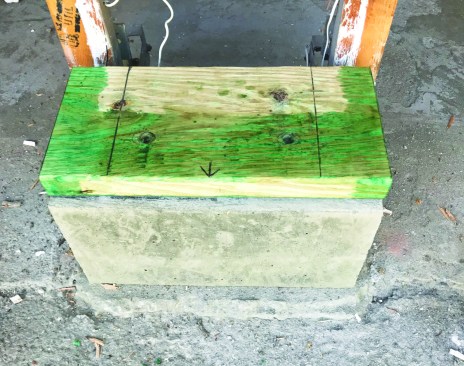 After letting the concrete cure, the author capped the footing with a treated 2x8 sill.