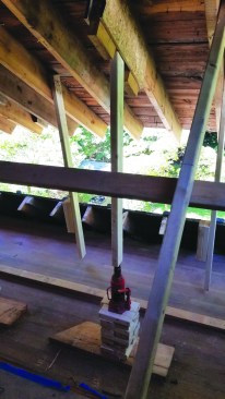 Instead of cutting new support posts for every lift cycle, they stacked cribbing made from 2-by scraps under the jacks.