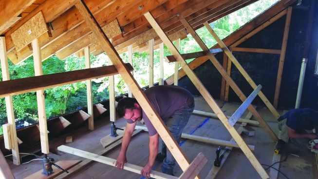 As the roof went up, the vertical supports footed against stops nailed to the dormer floor.