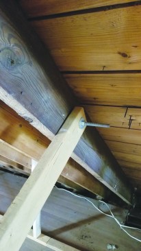 They also bolted 2x4 support posts to the rafters; the opposite ends of the 2x4s would come to rest against stops nailed to the floor as the roof went up.