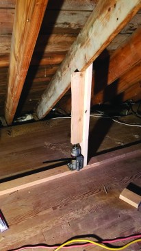 The straps went through holes in the roof and attached to the opposite roof. The crew also set up hydraulic jacks with lifting posts on the low part of the roof.