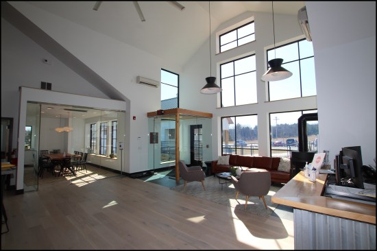 View of the completed second-floor entry lobby open to third-floor mezzanine level. A glass vestibule was installed as an air lock for that south entry’s door. A good industrial door closer was key because the building is located in a fairly windy area and gusts have the potential to rip the door out of your hand and slam it.