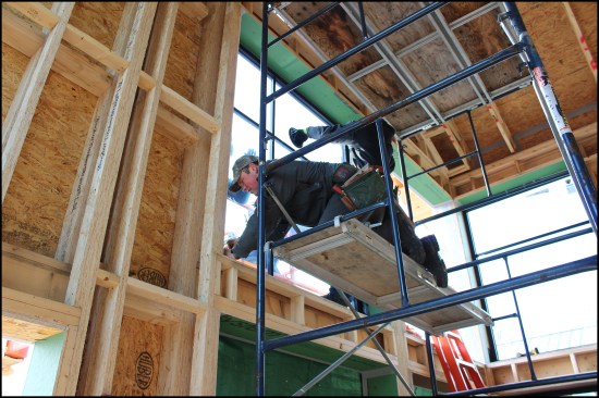 The window is inserted into the opening, set on the bearing blocks, then leveled from the interior (above).