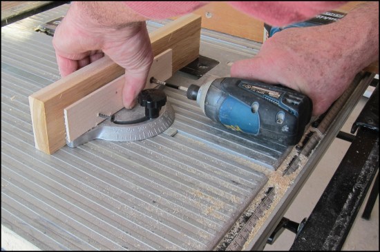 Here, the author attaches an auxiliary fence to the miter gauge. A backing piece of wood compensates for oversized screw holes through the gauge.