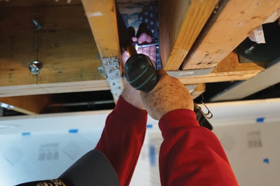 Every hole had to be filled with a fastener—a feat that can be challenging in narrow bays. Here Toby used an angle drive …