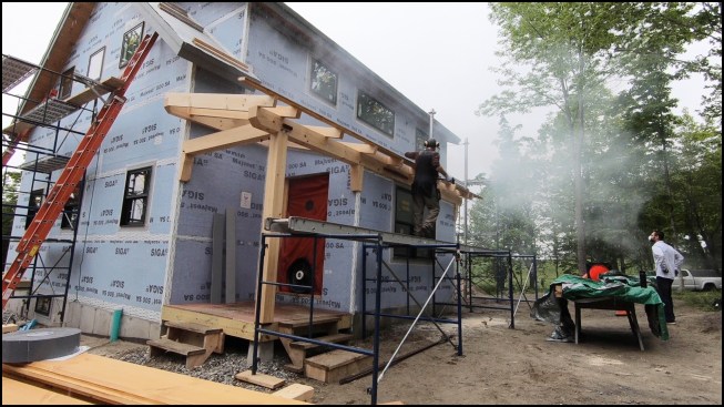 This modern take on a Cape has shed dormers front and back.