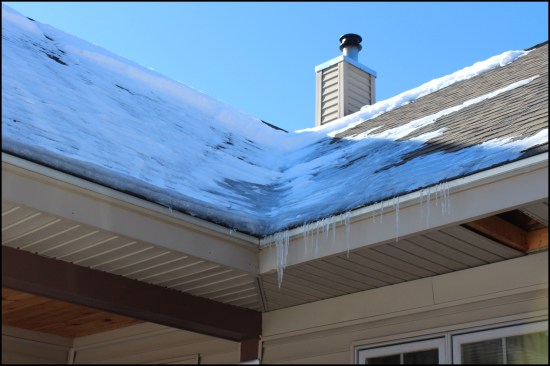 Heat loss from an exposed flue located in the transitional framing area where the roofs intersect (outside the existing thermal envelope) contributed to the ice damming, along with air leaks from the heated garage below the bonus room.