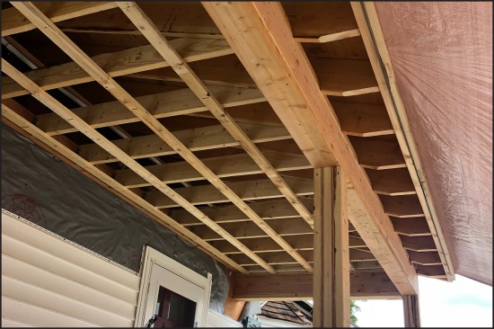 The laminated rough posts guard and triple 2x10 girder viewed from below. The laminated posts guard against potential twisting, something the author has seen with longer length pressure-treated SYP 6x6 stock.