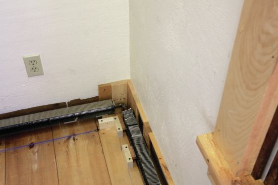 Base blocks are cut for a symetrical corner, and the next base block is spaced to match the adjacent wall.