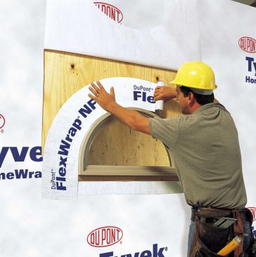 Flexible flashing stretches to seal around circular windows in a single pass. The housewrap then extends over the flashing.
