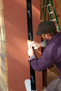 For places that are hard to get to with a roller (such as inside corners), use the butt of a cedar shingle to press the flashing tape firmly against the substrate on both sides of the corner.