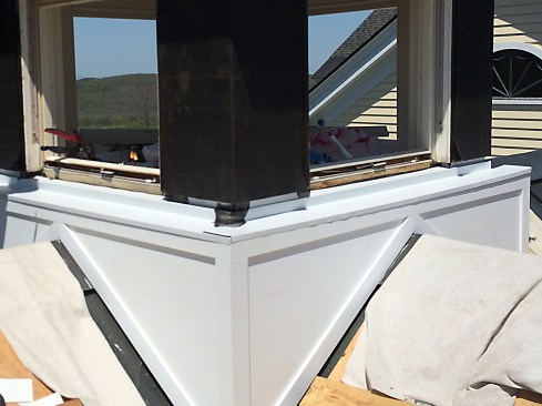 The awning’s sill was cut back approximately to where its operable hardware was concealed. Then, aluminum pan flashing was slipped under the existing sill about an inch, run up walls on either side of the awning.