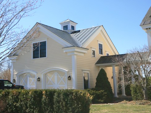 The carriage-house garage is attached to a house that sits up on a high, exposed site and the cupola’s prominent location on the roof subjects it to a regular pummeling of wind and rain. Each layer of new trim was designed to shed water away from the cupola and under each layer we installed an appropriate flashing. 