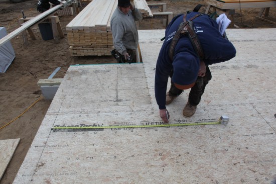 Because there was no perpendicular wall to use as a reference line for the short jog wall, the crew measured out from the corner (in the background) and from a second point on the wall.