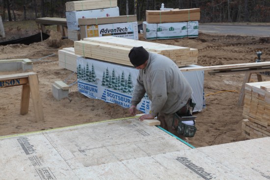 Measured off the baseline, the next corner is laid out. The position of this corner will be finalized during the squaring process.